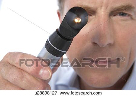 Stock Photo - Doctor holding an otoscope. Fotosearch