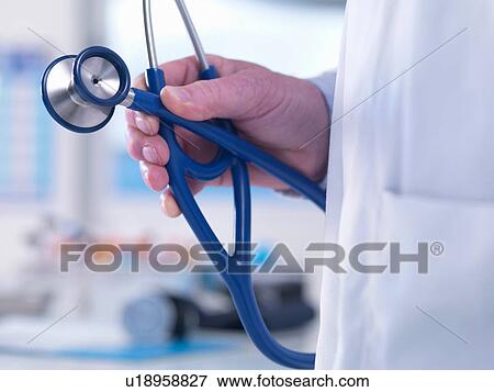 Doctor offering advice to a patient in a clinic View Large Photo Image Stock Photo - Doctor offering advice to a patient in a clinic. Fotosearch