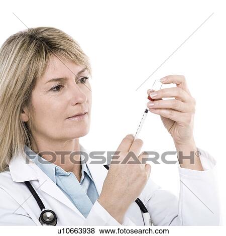 Stock Photo - Doctor preparing a syringe. Fotosearch