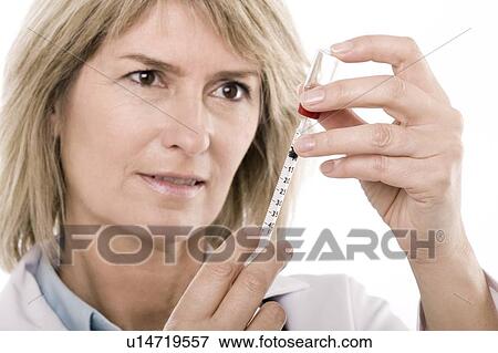 Doctor preparing a syringe View Large Photo Image Stock Photo - Doctor preparing a syringe. Fotosearch