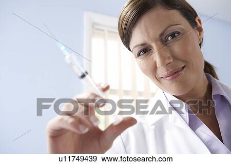 Stock Photo - Doctor preparing an injection. Fotosearch