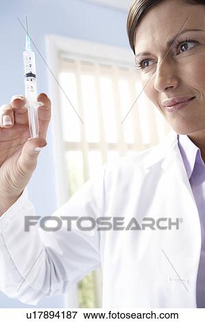 Doctor preparing an injection View Large Photo Image Stock Photo - Doctor preparing an injection. Fotosearch