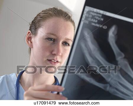 Stock Photo - Doctor studying an X-ray. Fotosearch