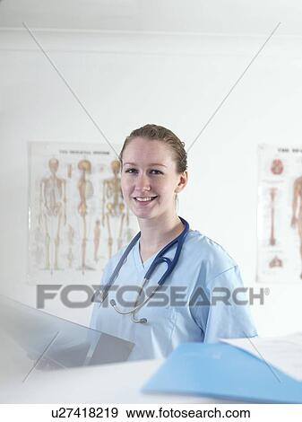 Stock Photo - Doctor studying an X-ray. Fotosearch