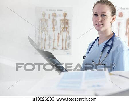 Doctor studying an X-ray View Large Photo Image Stock Photograph - Doctor studying an X-ray. Fotosearch