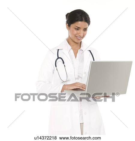 Doctor using a laptop View Large Photo Image Stock Photo - Doctor using a laptop. Fotosearch