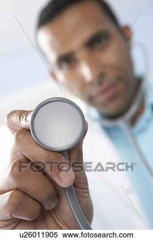 Stock Photography - Doctor using a stethoscope. Fotosearch