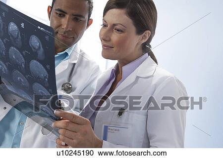 Doctors examining MRI scans View Large Photo Image Stock Image - Doctors examining MRI scans. Fotosearch