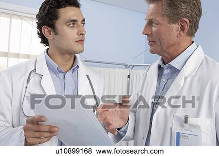 Doctors talking View Large Photo Image Stock Photo - Doctors talking. Fotosearch