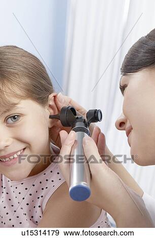 Ear examination View Large Photo Image Stock Photo - Ear examination. Fotosearch