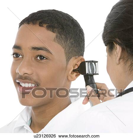 Ear examination View Large Photo Image Stock Photograph - Ear examination. Fotosearch