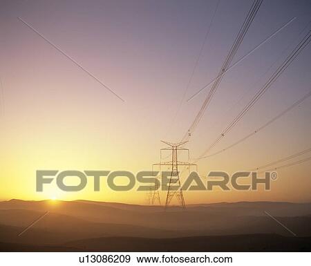 Stock Photo - Electricity pylons at sunset. Fotosearch