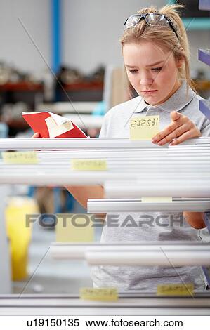 Factory worker stock taking metal rods in roller blind factory View Large Photo Image Stock Photography - Factory worker stock taking metal rods in roller blind factory. Fotosearch