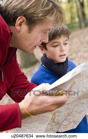 Picture - Father and son reading a map. Fotosearch