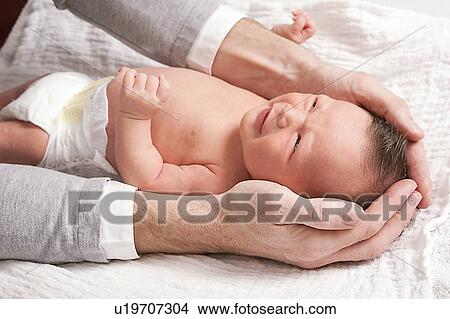 Father touching newborn baby View Large Photo Image Picture - Father touching newborn baby. Fotosearch