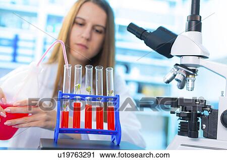 Female biologist squeezing liquid View Large Photo Image Stock Image - Female biologist squeezing liquid. Fotosearch