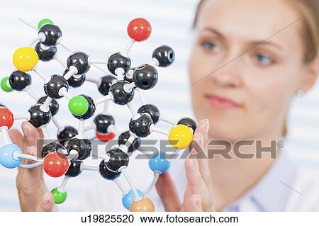 Female chemist examining molecular model View Large Photo Image Stock Image - Female chemist examining molecular model. Fotosearch