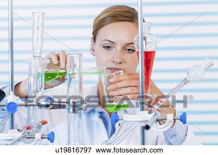Female chemist pouring chemicals View Large Photo Image Stock Photo - Female chemist pouring chemicals. Fotosearch