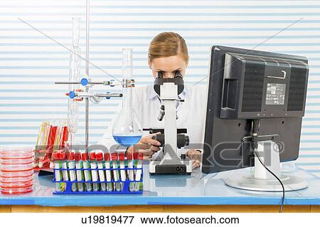 Female chemist using microscope View Large Photo Image Stock Photo - Female chemist using microscope. Fotosearch