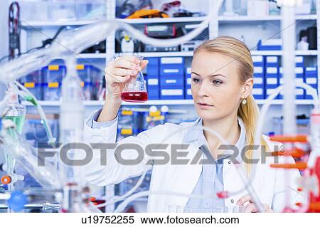 Stock Photography - Female chemist working in lab. Fotosearch