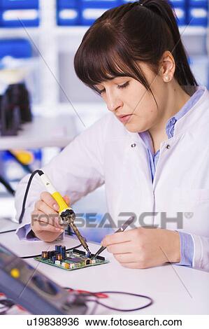 Stock Photograph - Female electrical engineer testing. Fotosearch