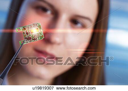 Stock Photo - Female electrical engineer with chip. Fotosearch