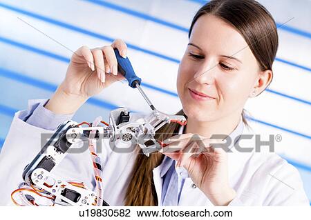 Stock Image - Female electrical engineer working. Fotosearch