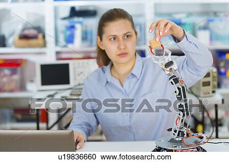 Stock Image - Female electrical engineer working. Fotosearch
