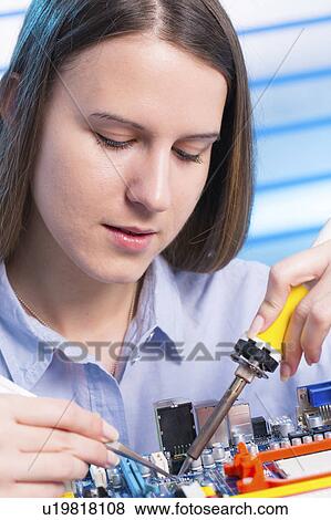 Stock Photo - Female electrical engineer working. Fotosearch