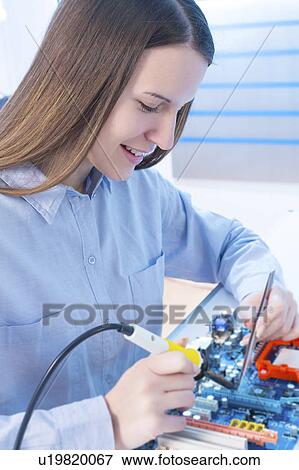 Stock Photo - Female electrical engineer working. Fotosearch