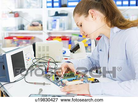 Stock Photo - Female electrical engineer working. Fotosearch