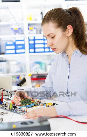 Stock Photo - Female electrical engineer working. Fotosearch
