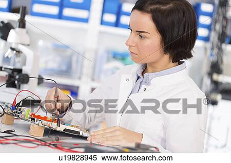 Stock Photography - Female electrical engineer working. Fotosearch