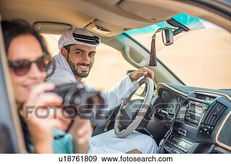 Female tourist in off road vehicle in desert taking photographs, Dubai, United Arab Emirates View Large Photo Image Stock Photo - Female tourist in off road vehicle in desert taking photographs, Dubai, United Arab Emirates. Fotosearch
