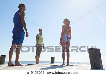 Fiends wearing sports clothes standing on pier View Large Photo Image Stock Photography - Fiends wearing sports clothes standing on pier. Fotosearch