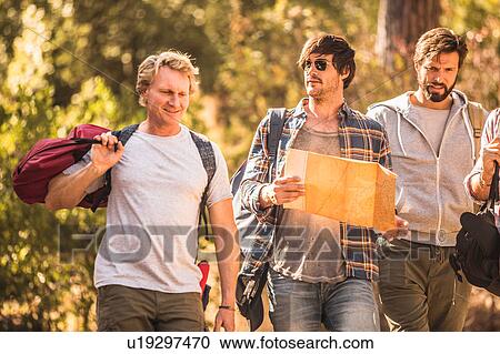 Four male hikers hiking through forest with map, Deer Park, Cape Town, South Africa View Large Photo Image Stock Image - Four male hikers hiking through forest with map, Deer Park, Cape Town, South Africa. Fotosearch