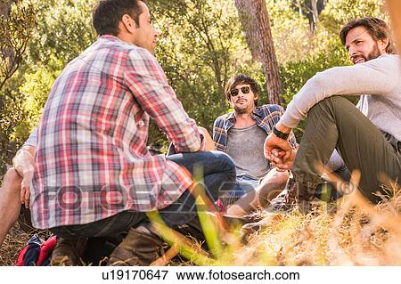 Four male hikers taking a break in forest, Deer Park, Cape Town, South Africa View Large Photo Image Stock Photo - Four male hikers taking a break in forest, Deer Park, Cape Town, South Africa. Fotosearch