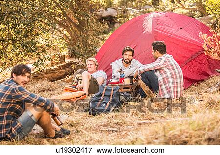 Four men camping in forest drinking beer and coffee, Deer Park, Cape Town, South Africa View Large Photo Image Stock Photo - Four men camping in forest drinking beer and coffee, Deer Park, Cape Town, South Africa. Fotosearch