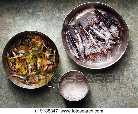 Fresh sardines in salt in pan, overhead view View Large Photo Image Stock Photo - Fresh sardines in salt in pan, overhead view. Fotosearch