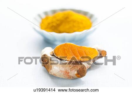 Picture - Fresh turmeric root and dried powder. Fotosearch