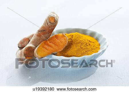 Stock Image - Fresh turmeric root and dried powder. Fotosearch