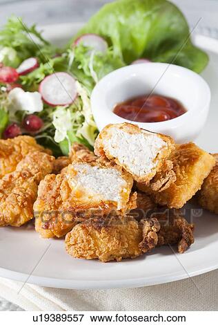 Stock Photo - Fried chicken with salad and sauce. Fotosearch