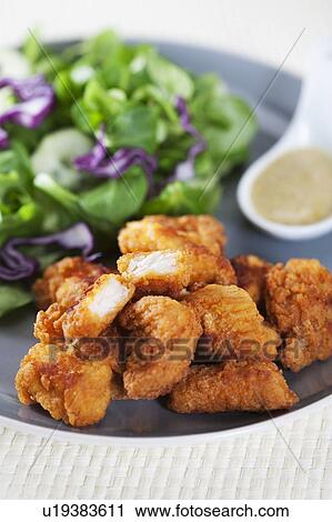 Stock Image - Fried chicken with salad. Fotosearch