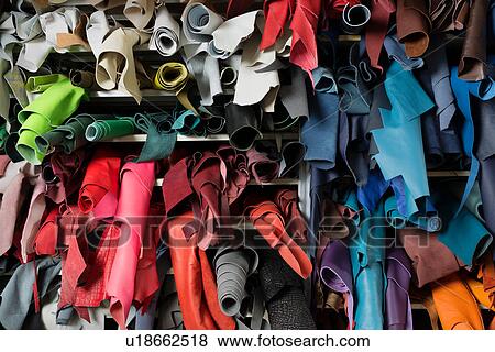 Stock Photo - Full frame view of shelves of leather skins. Fotosearch