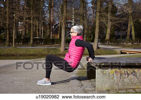 Full length side view of woman doing reverse push up View Large Photo Image Stock Image - Full length side view of woman doing reverse push up. Fotosearch