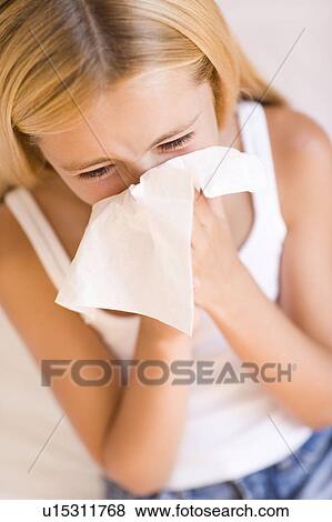 Girl blowing her nose View Large Photo Image Stock Photo - Girl blowing her nose. Fotosearch