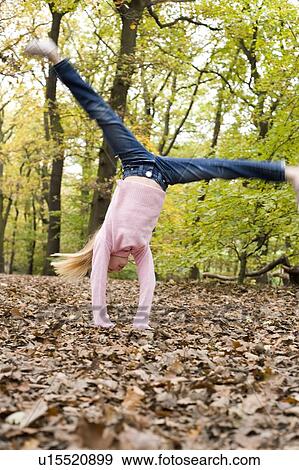 Stock Photo - Girl cart-wheeling. Fotosearch