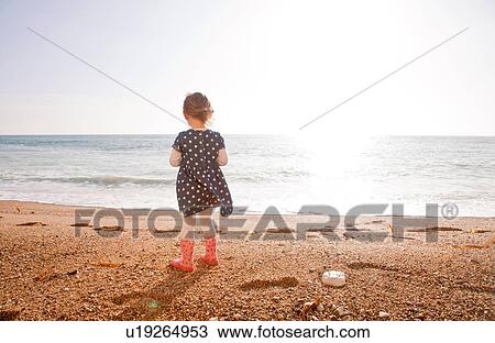 Stock Image - Girl enjoying beach, Man O'War Beach, Dorset. Fotosearch
