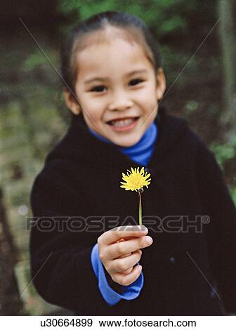 Stock Photo - Girl holding a flower. Fotosearch