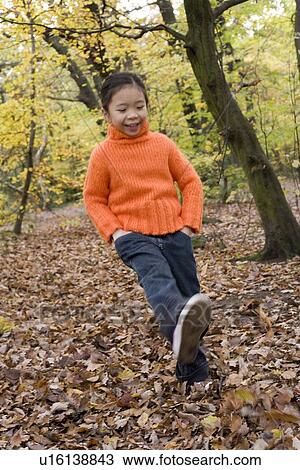Girl kicking leaves View Large Photo Image Stock Image - Girl kicking leaves. Fotosearch